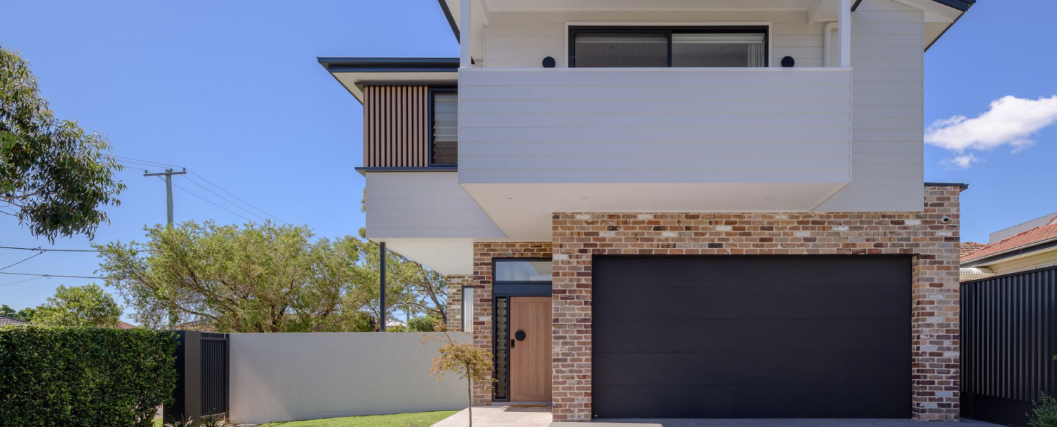 Modern residential entrance with aluminium-framed glazed doors and windows